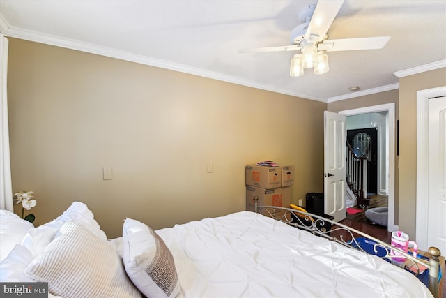 bedroom with ceiling fan and crown molding