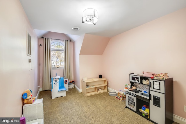 rec room featuring carpet flooring and vaulted ceiling