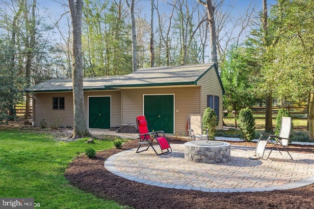 back of house featuring a patio, an outdoor fire pit, and a lawn