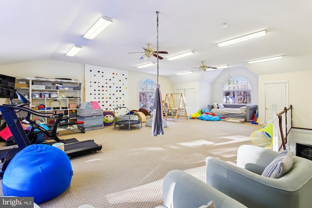 interior space with ceiling fan, carpet floors, and vaulted ceiling