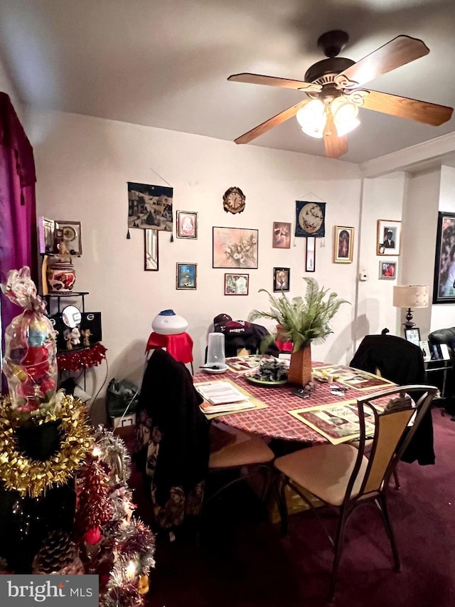 carpeted dining space with ceiling fan