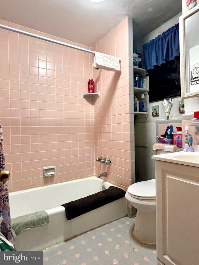 full bathroom featuring vanity, toilet, and tiled shower / bath combo