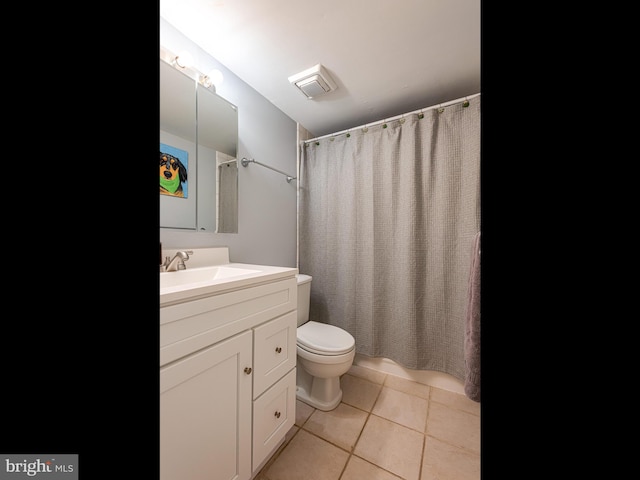 bathroom featuring vanity, toilet, curtained shower, and tile patterned flooring