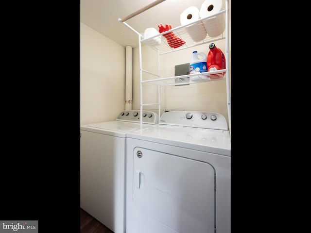 clothes washing area with washing machine and dryer