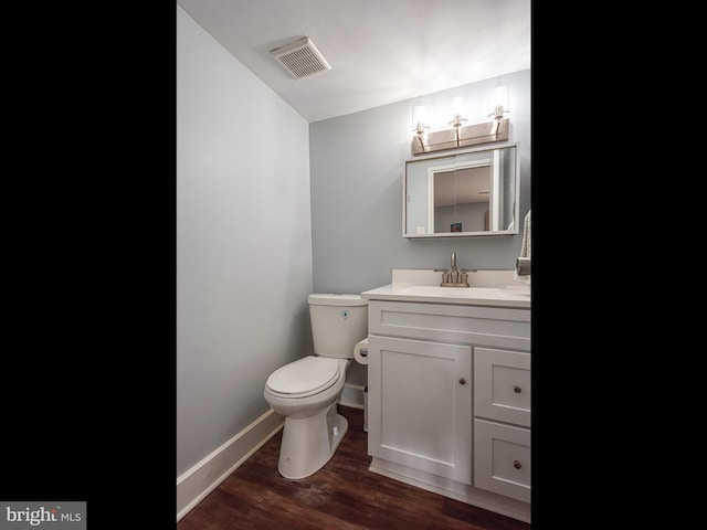 bathroom featuring hardwood / wood-style flooring, vanity, and toilet