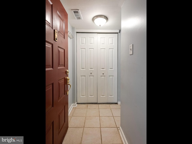 doorway to outside featuring light tile patterned floors