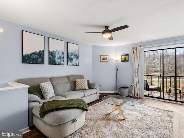 living room featuring ceiling fan and wood-type flooring