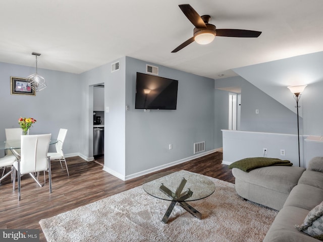 living room with dark hardwood / wood-style floors and ceiling fan