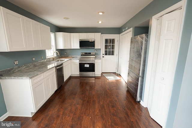 kitchen with sink, white cabinets, stainless steel appliances, and dark hardwood / wood-style floors