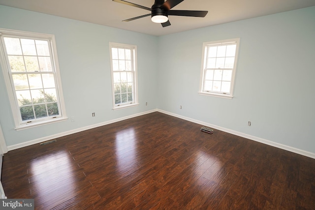 empty room with dark hardwood / wood-style floors and ceiling fan