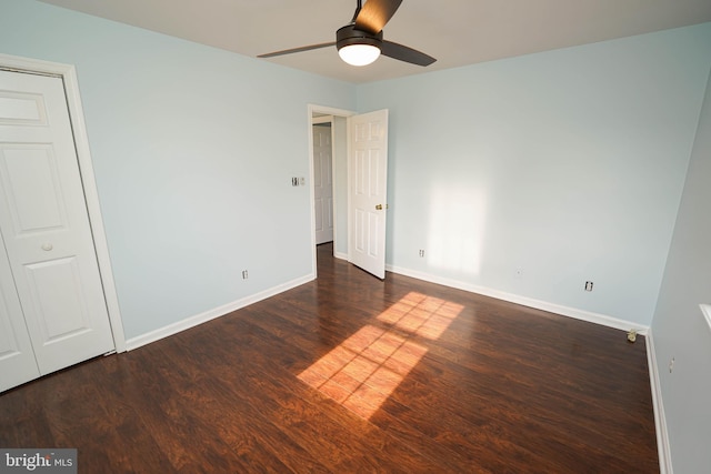 unfurnished bedroom with dark hardwood / wood-style flooring and ceiling fan