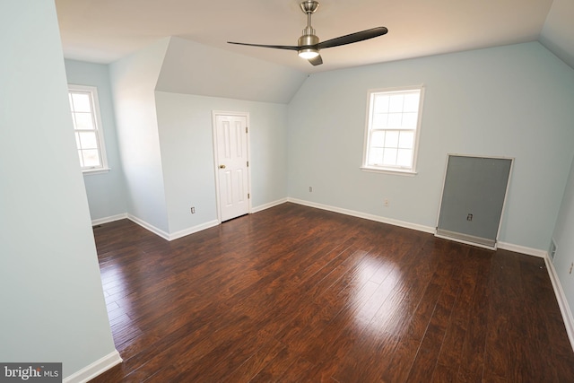 additional living space with ceiling fan, dark wood-type flooring, and vaulted ceiling