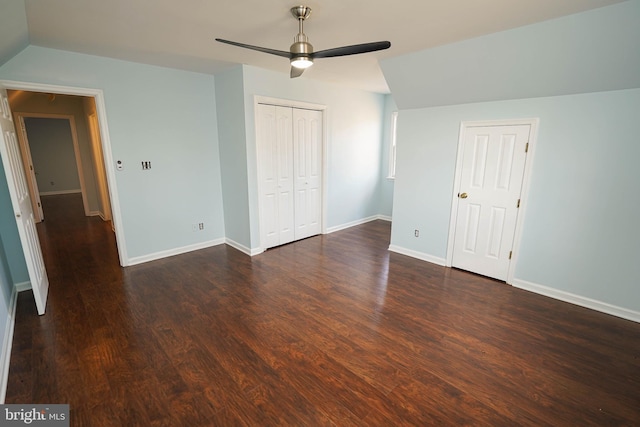 unfurnished bedroom with ceiling fan, dark hardwood / wood-style flooring, and lofted ceiling