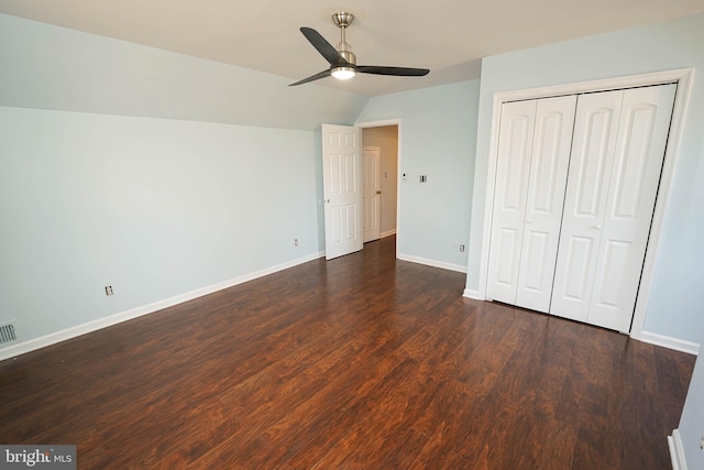 unfurnished bedroom featuring dark hardwood / wood-style flooring, a closet, ceiling fan, and lofted ceiling