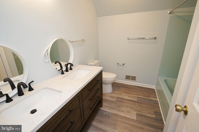 bathroom with vanity, toilet, and wood-type flooring