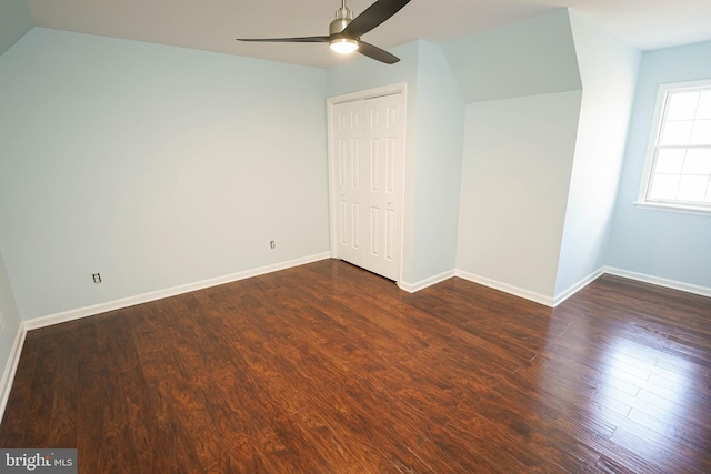 interior space with ceiling fan, lofted ceiling, and dark wood-type flooring