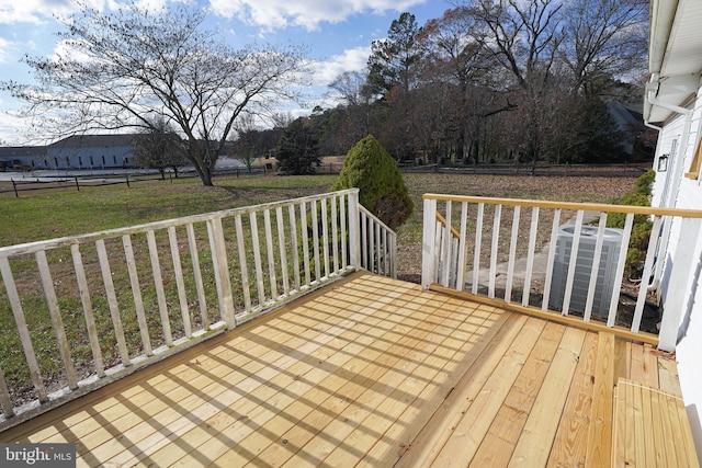 wooden terrace featuring a lawn and central AC