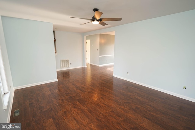 spare room with ceiling fan and dark wood-type flooring