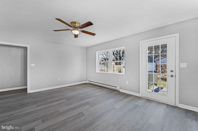 unfurnished room with baseboard heating, ceiling fan, and dark wood-type flooring