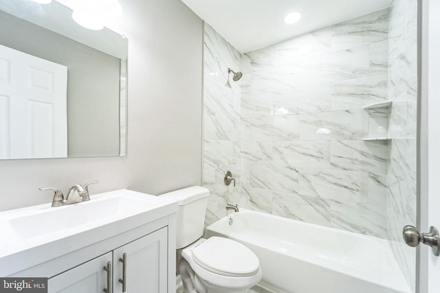 full bathroom featuring toilet, vanity, and tiled shower / bath