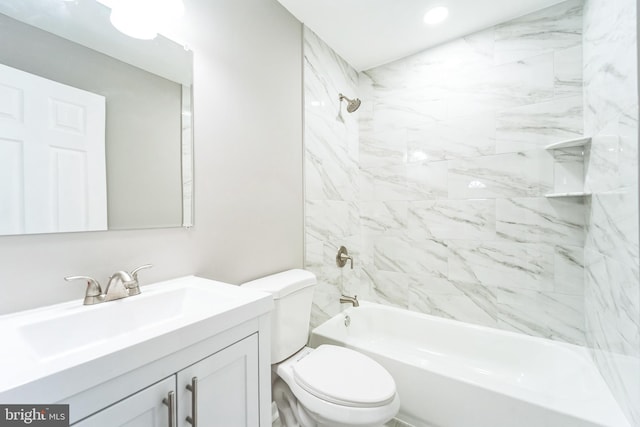 full bathroom featuring tiled shower / bath combo, toilet, and vanity