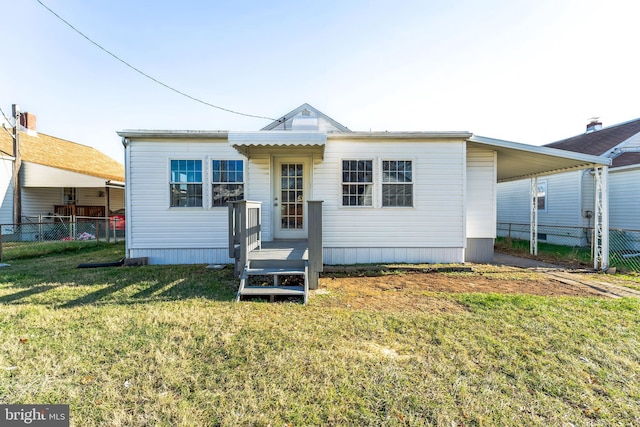 rear view of property featuring a yard