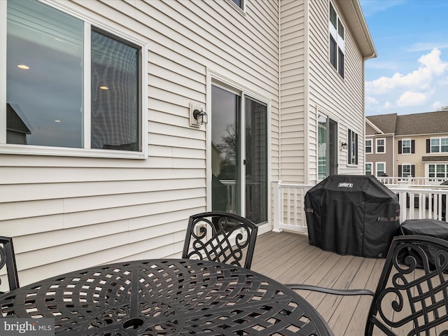 wooden deck featuring a grill