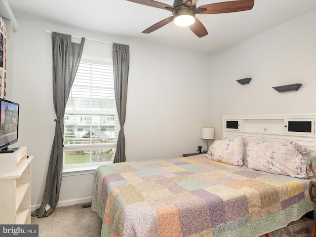 bedroom featuring carpet flooring, multiple windows, and ceiling fan