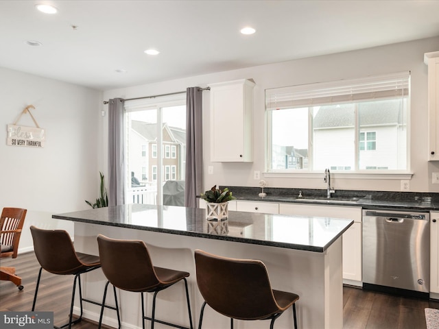 kitchen featuring dishwasher, a center island, white cabinets, and sink