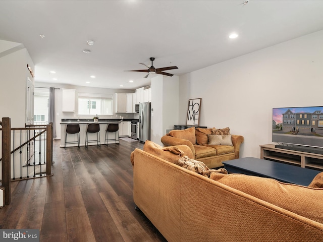 living room with dark hardwood / wood-style floors and ceiling fan