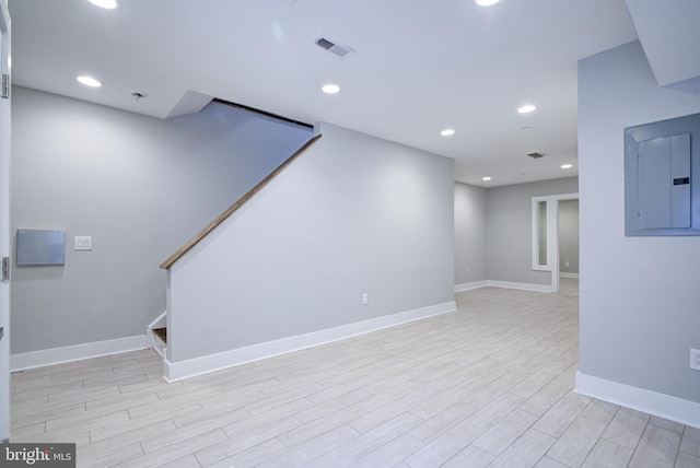 interior space with electric panel and light hardwood / wood-style floors