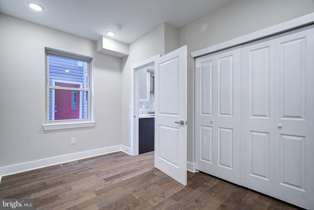 interior space featuring a closet and dark wood-type flooring