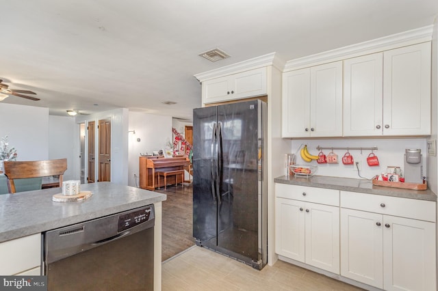 kitchen featuring ceiling fan, light hardwood / wood-style flooring, stainless steel dishwasher, black refrigerator, and white cabinets