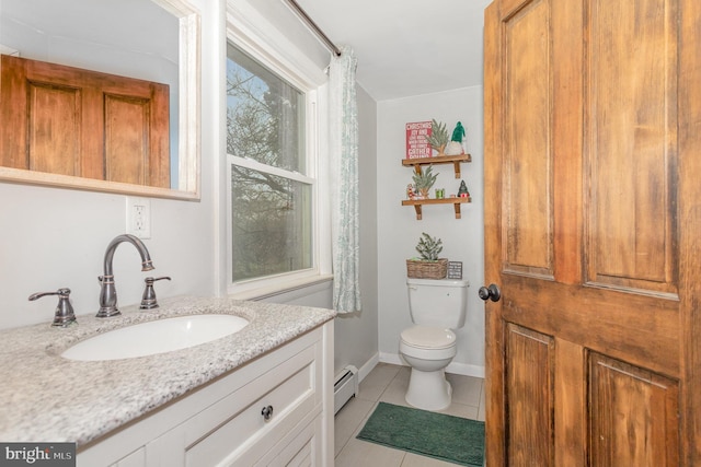 bathroom with baseboard heating, tile patterned flooring, vanity, and toilet