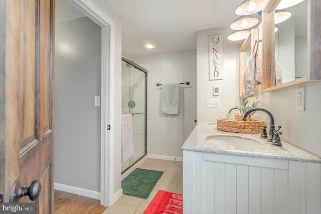 bathroom with tile patterned floors, vanity, and a shower with shower door