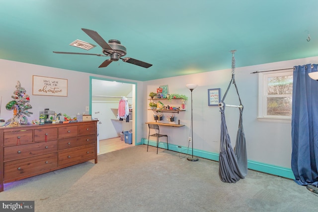 interior space featuring ceiling fan and light colored carpet