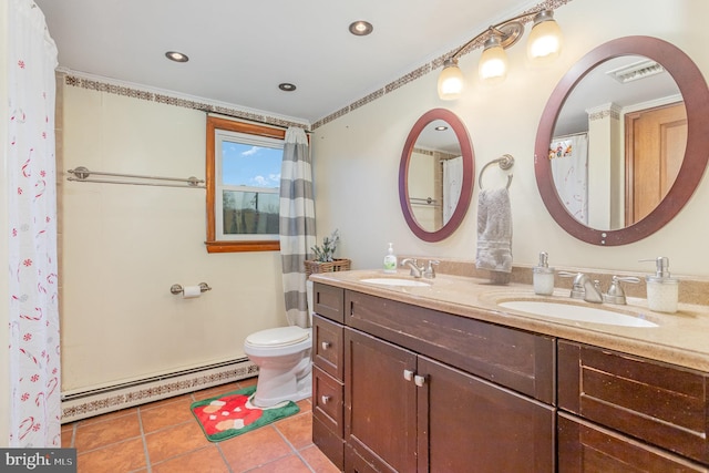 bathroom featuring toilet, vanity, tile patterned floors, and a baseboard heating unit