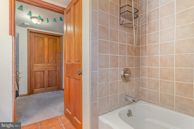 bathroom featuring tile patterned flooring and tiled shower / bath combo