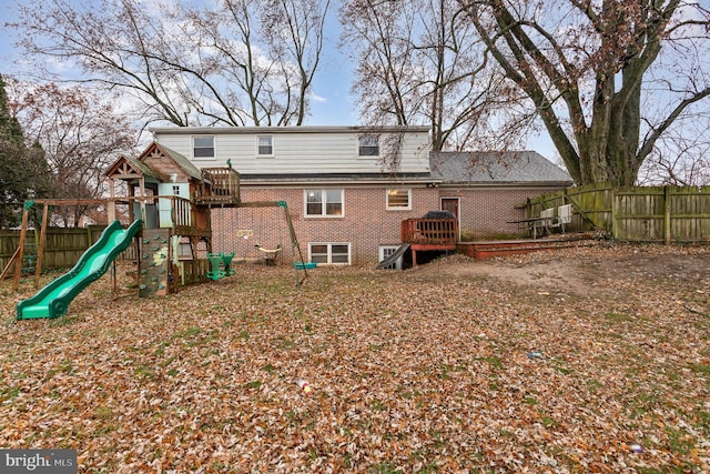 back of house with a playground