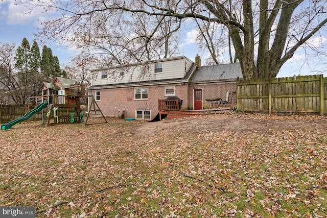 rear view of house with a playground