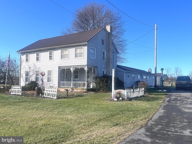 view of front of house with a porch and a front yard