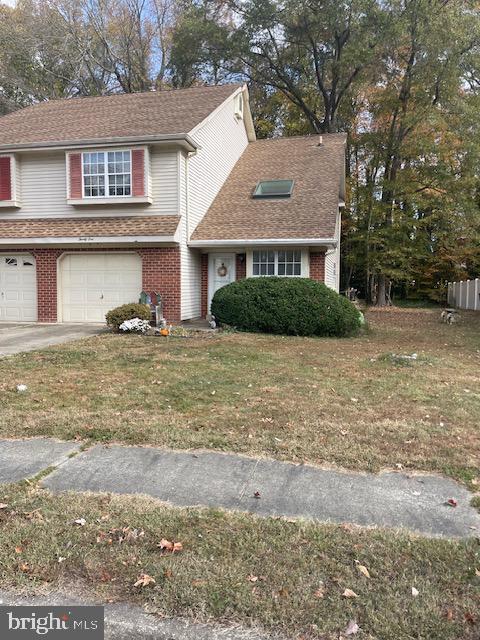 view of front of property featuring a garage and a front lawn