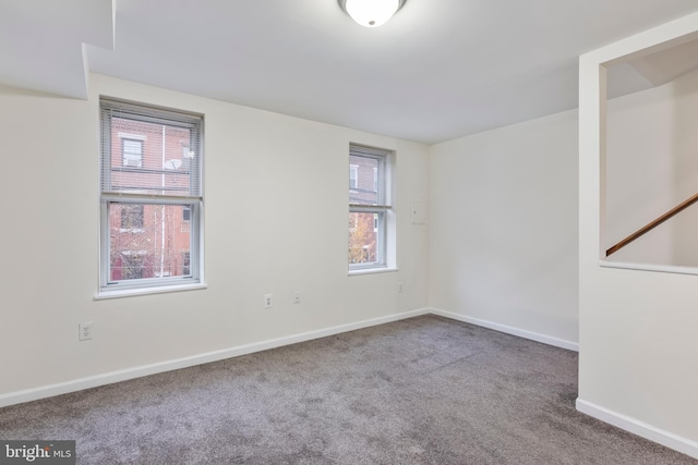 carpeted empty room with plenty of natural light