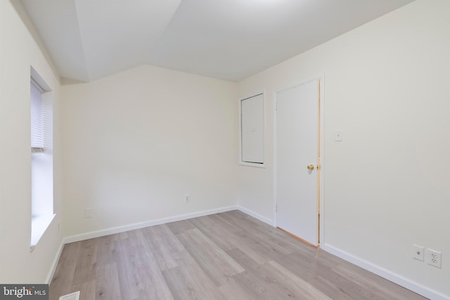 empty room featuring light hardwood / wood-style flooring and lofted ceiling