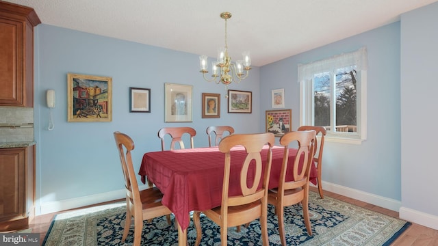 dining room featuring light hardwood / wood-style floors and an inviting chandelier