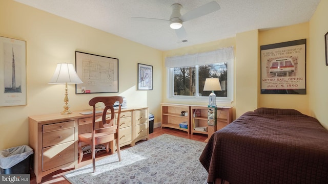 bedroom featuring ceiling fan, a textured ceiling, and hardwood / wood-style flooring