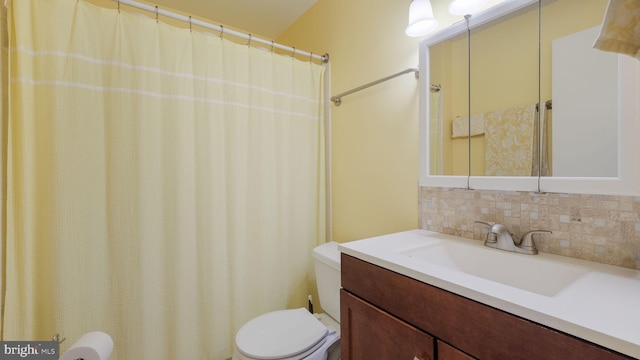 bathroom with vanity, tasteful backsplash, and toilet