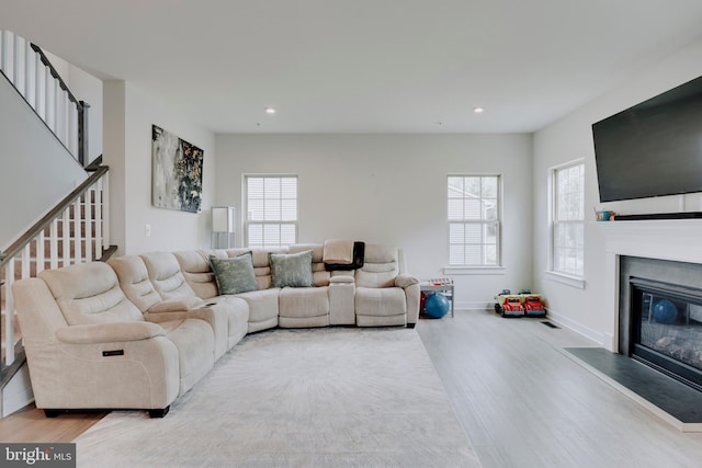 living room featuring a healthy amount of sunlight and light hardwood / wood-style flooring