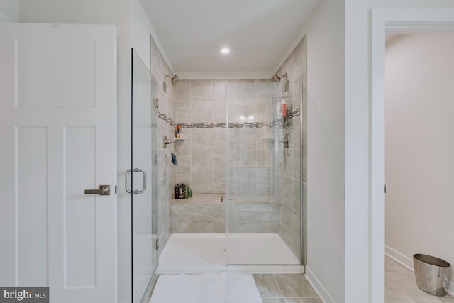 bathroom featuring tile patterned flooring and a shower with door