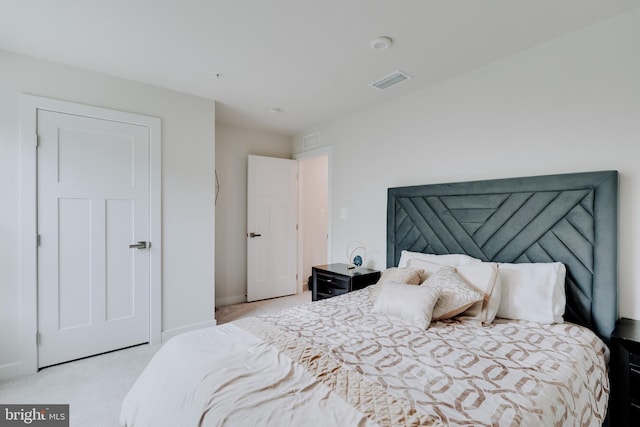 bedroom featuring light colored carpet